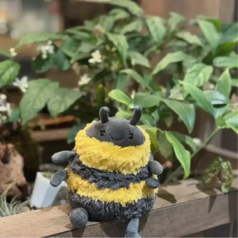Cute fat bumblebee plush toy outdoors, soft bee stuffed animal gift for kids