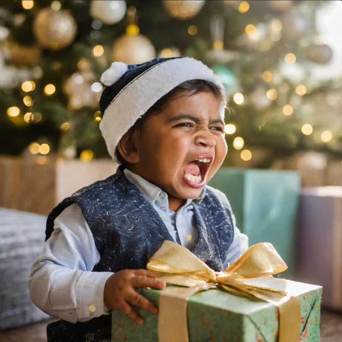 A wrapped green present with a gold bow.